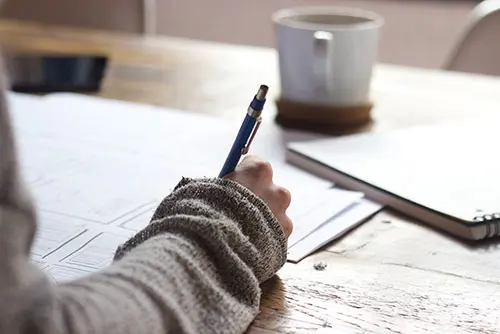 Person writing on notepad